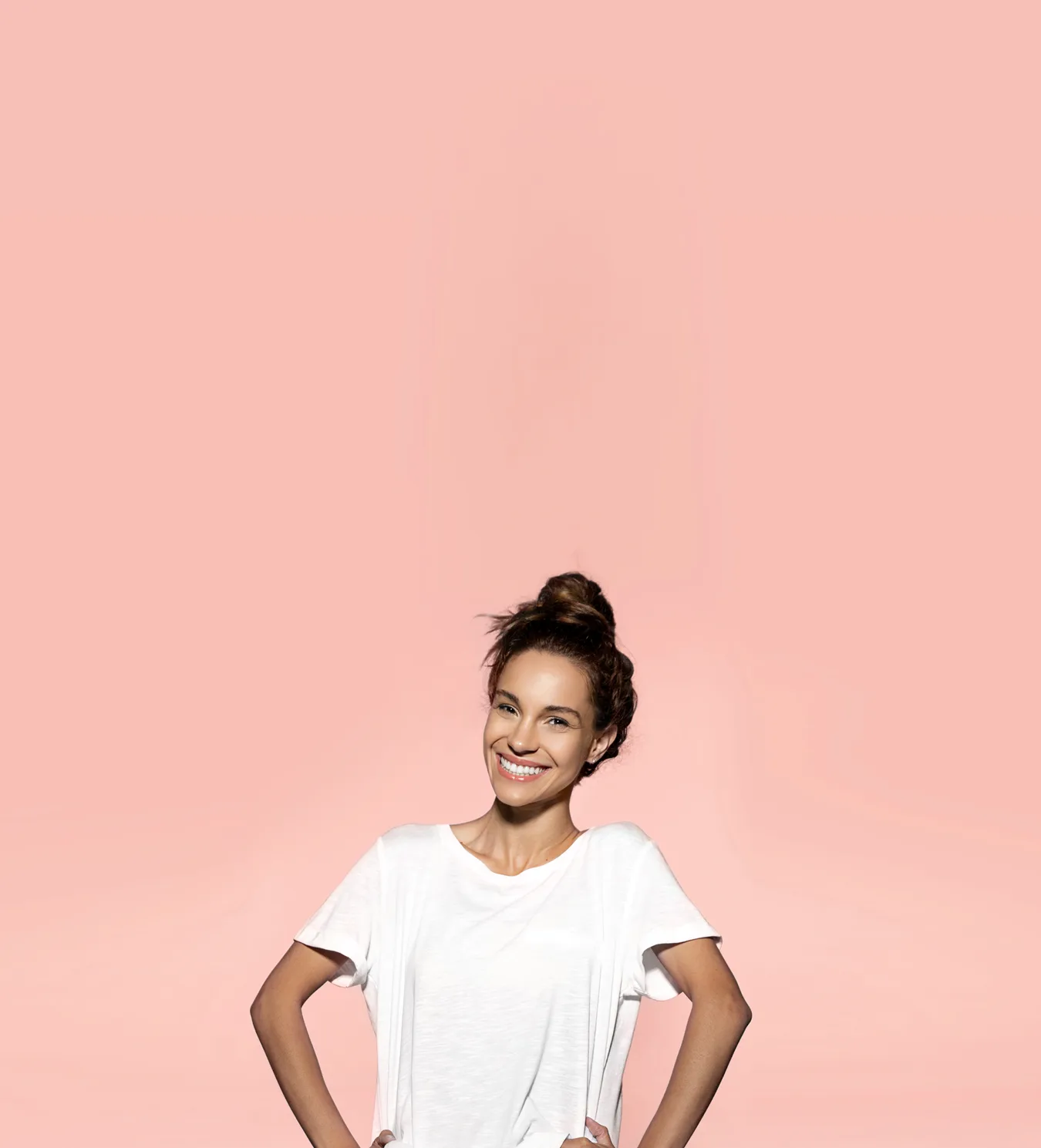 Woman smiling with hands on hips